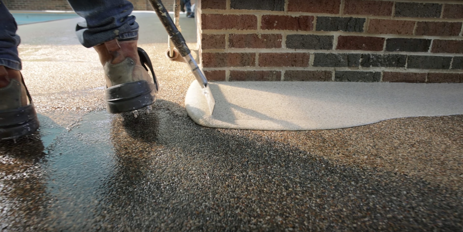 Expert concrete finishing techniques for pool deck restoration Professional concrete contractor applying smooth finish to pool deck surface