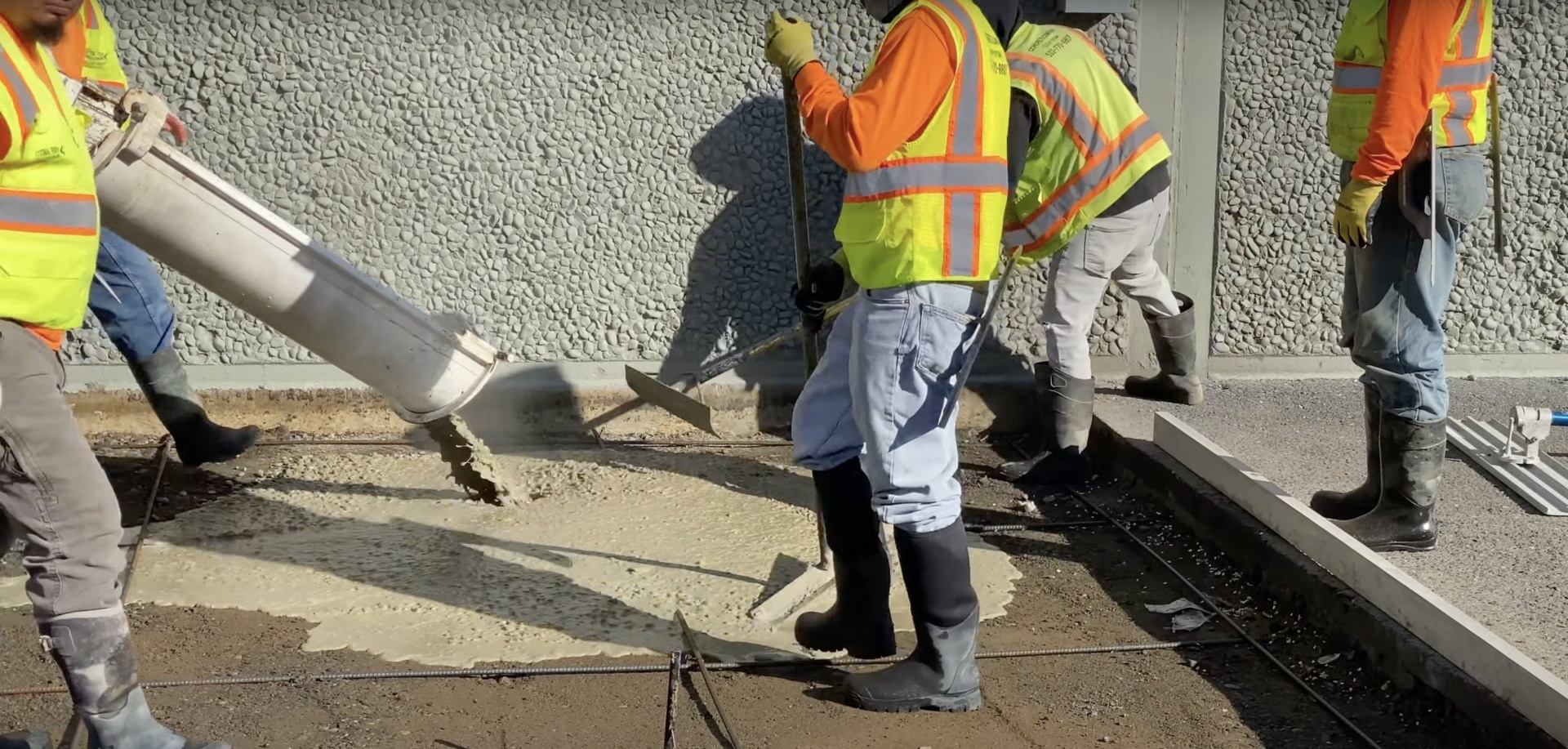 Expert foundation concrete pouring with professional construction team Professional concrete crew pouring foundation with specialized equipment and safety gear