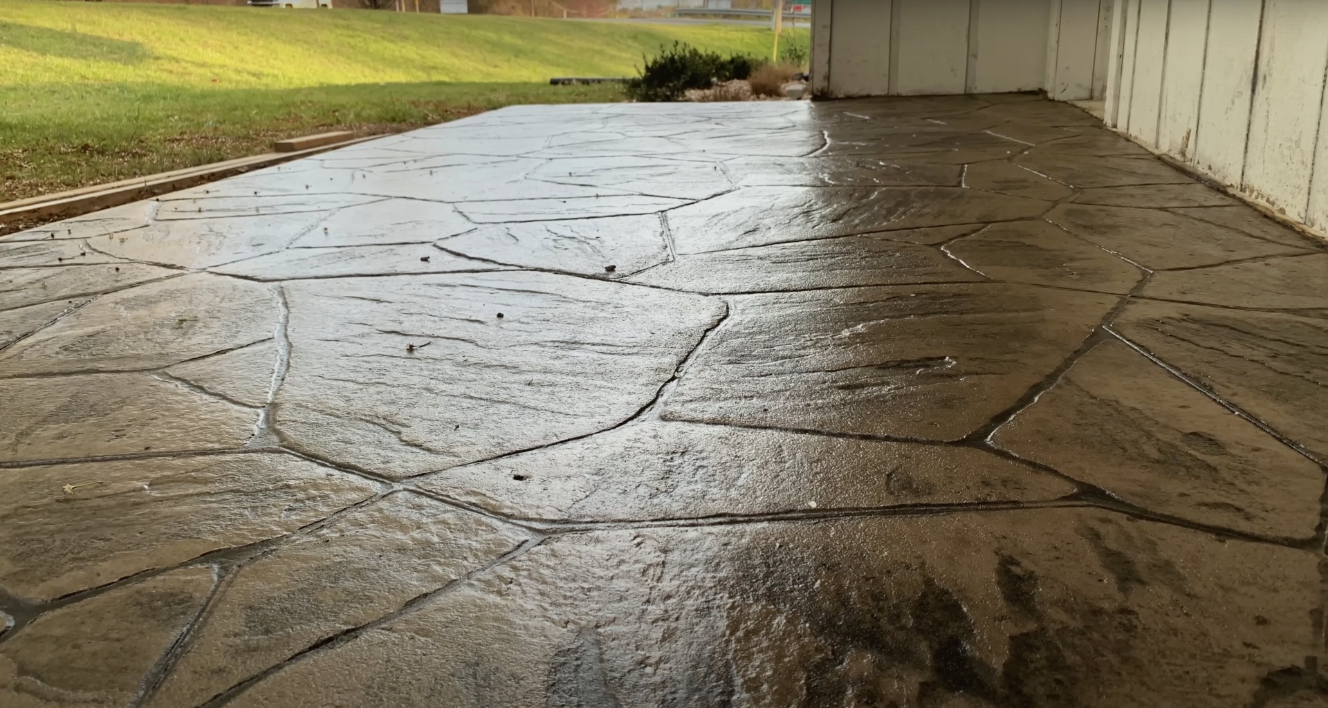 Damaged concrete driveway demonstrating need for professional repair services Cracked concrete driveway showing damage from settling and weather exposure