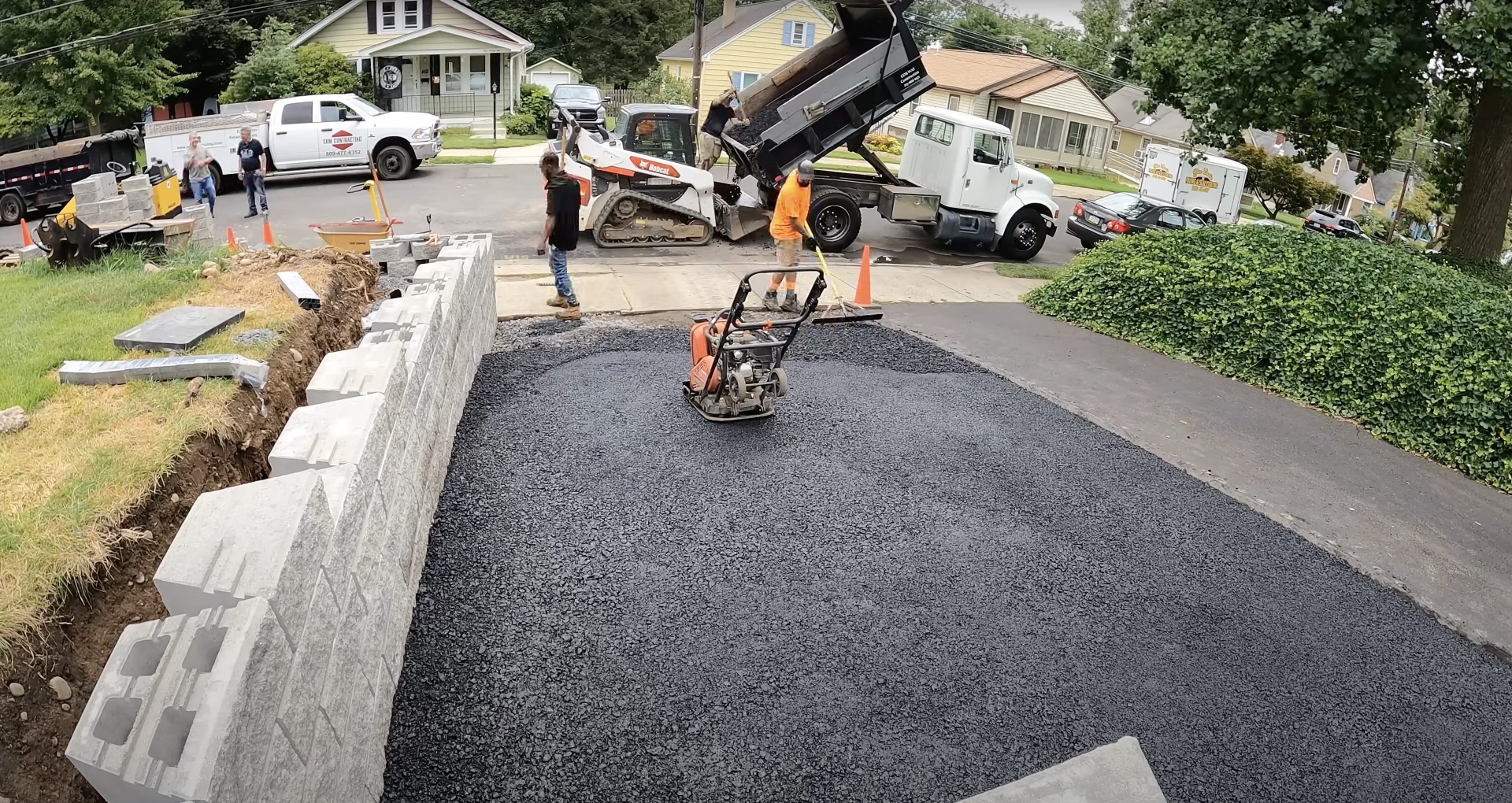 Expert driveway construction using professional grade equipment and materials Professional asphalt and concrete driveway installation with commercial equipment