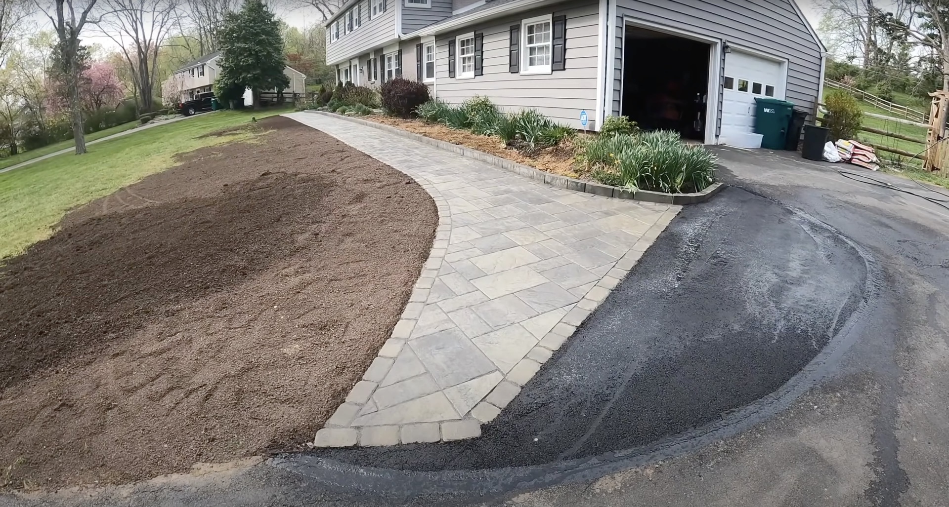 Beautiful concrete driveway installation with decorative pavers in Bartlett TN