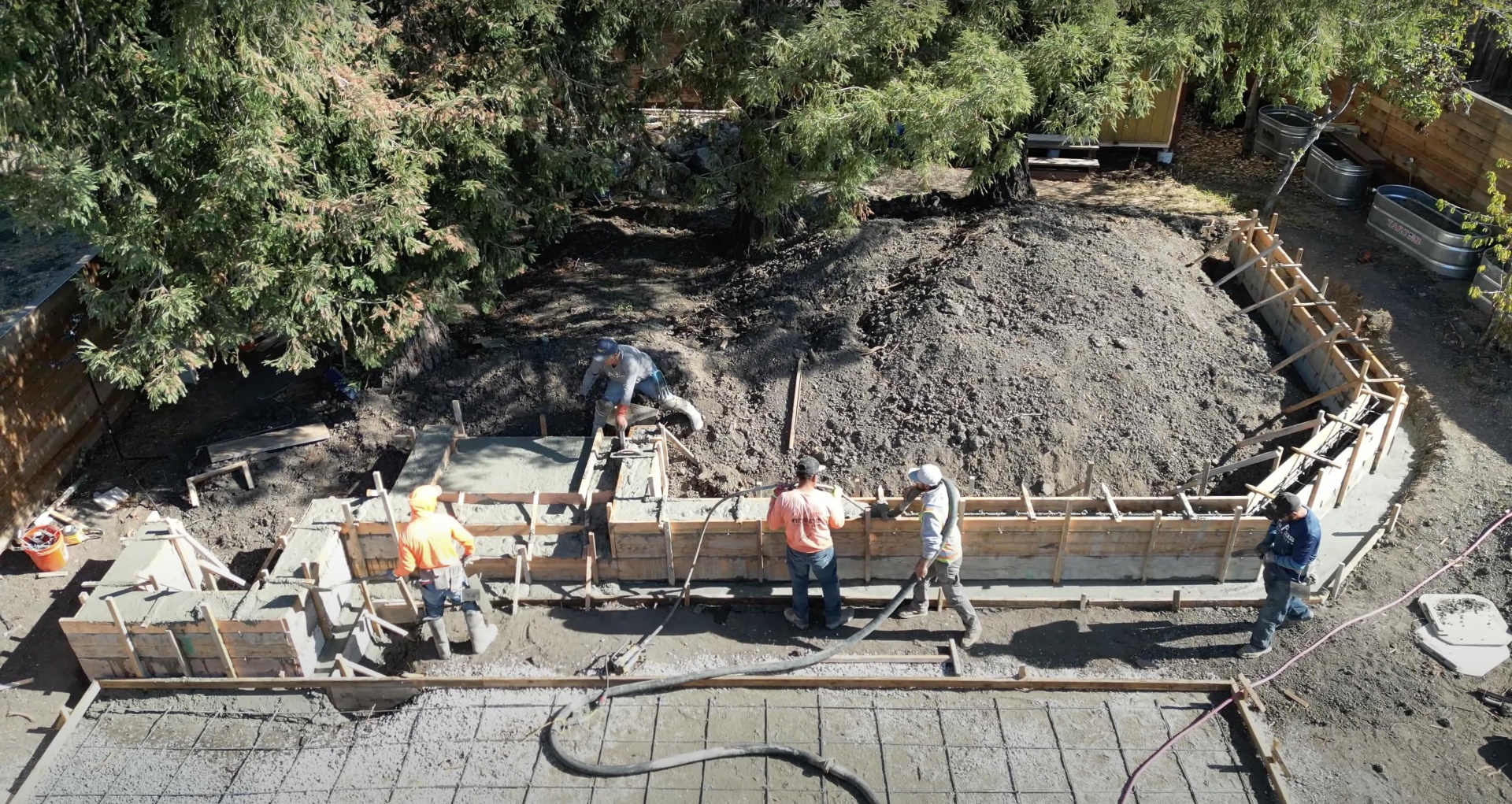 Expert concrete contractors preparing foundation work with professional equipment Professional concrete construction crew working on foundation forms and preparation